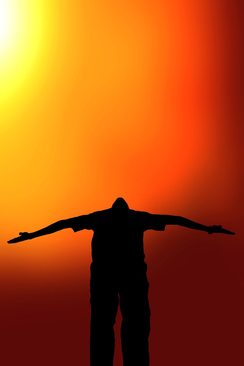 the silhouette of a person is in front of a bright sun