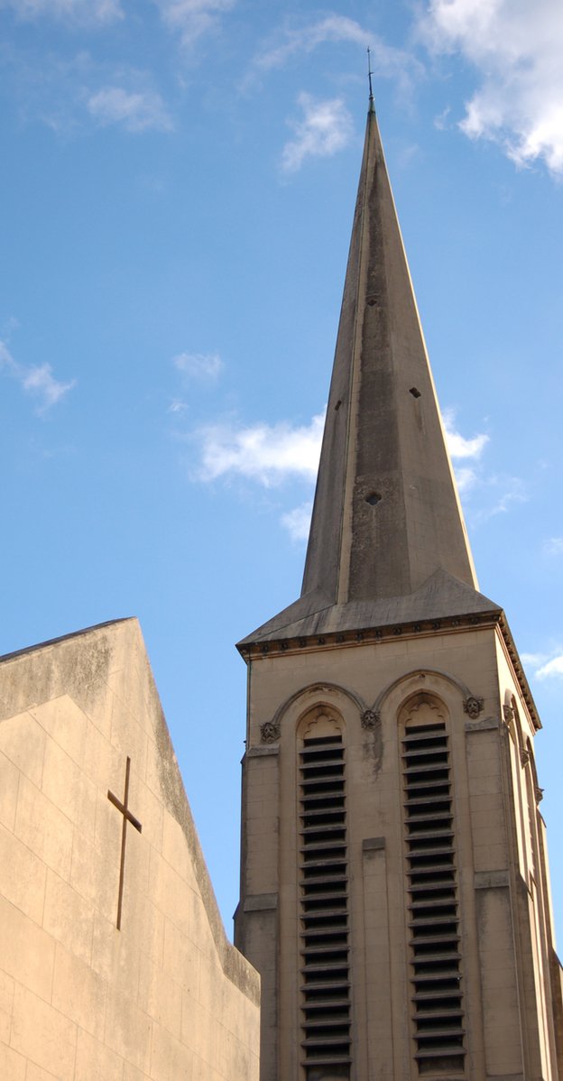 a church steeple is shown from the bottom and with the cross on top