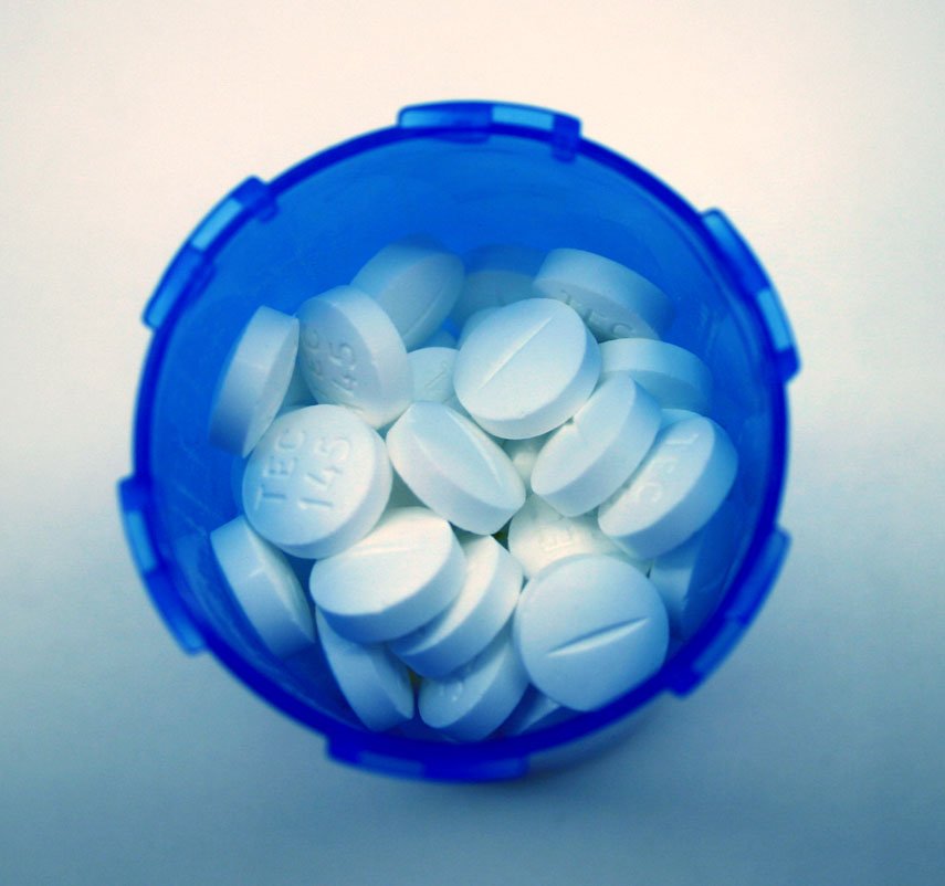 there is a container that contains white pills