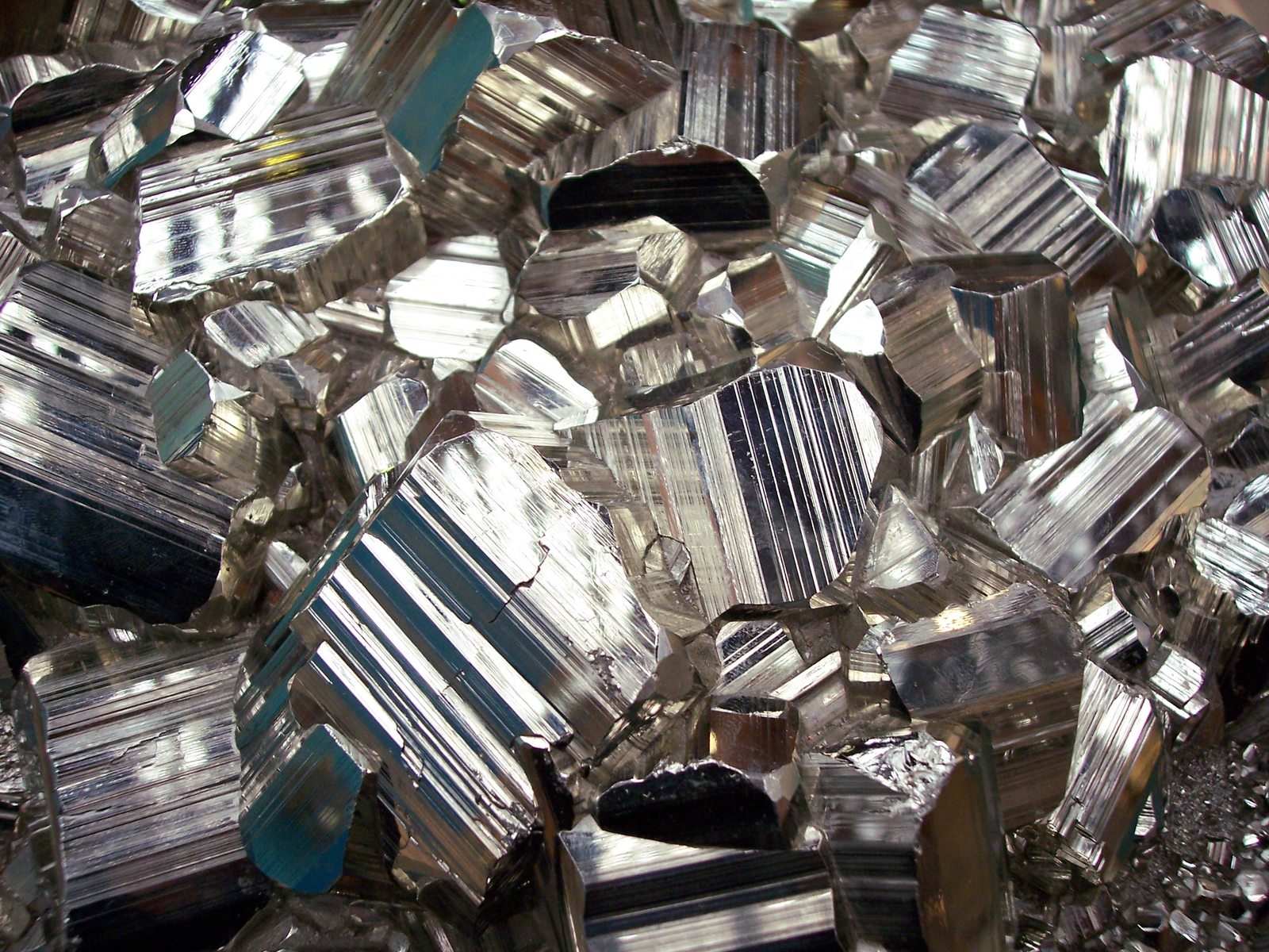 a pile of silver and glass blocks that are broken and sitting in the rubble