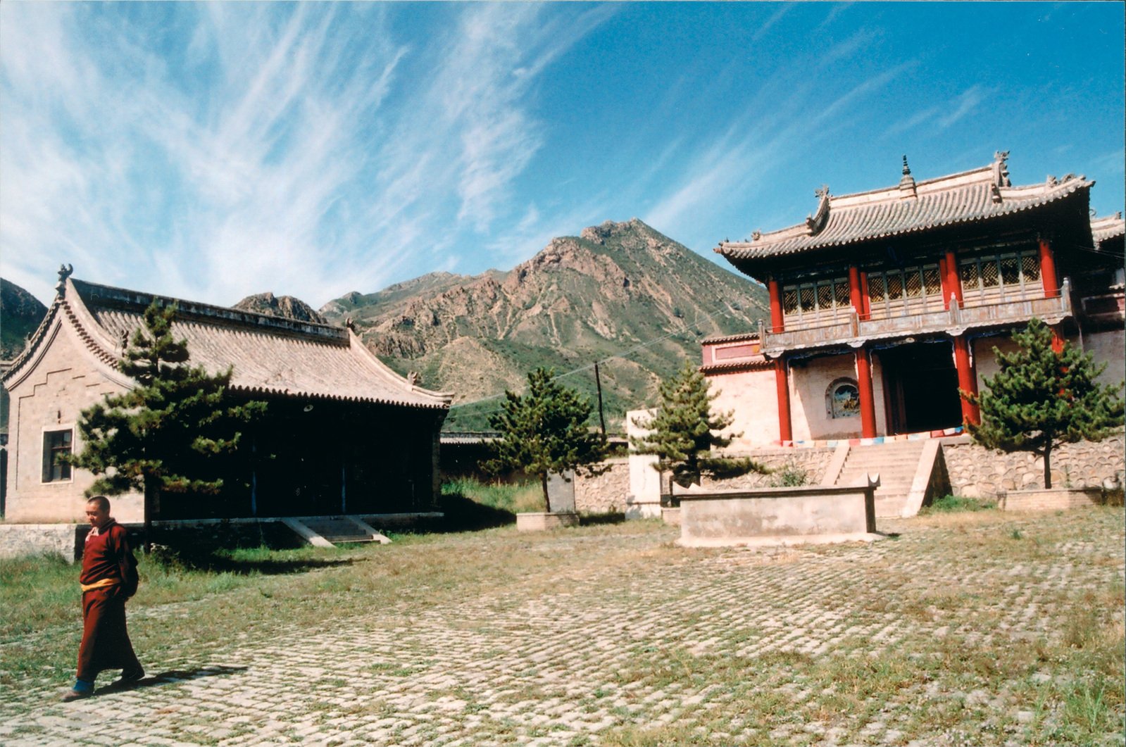 a man with a backpack standing in front of an old building