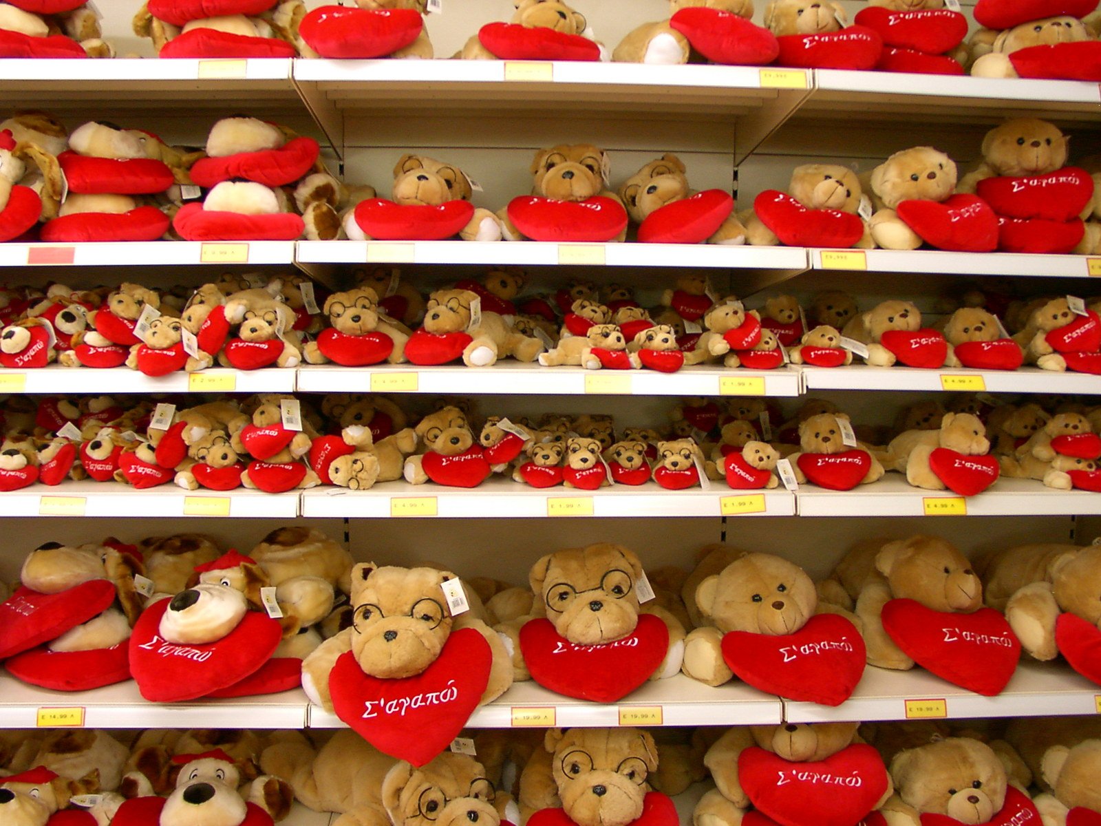 shelves filled with red and beige teddy bears