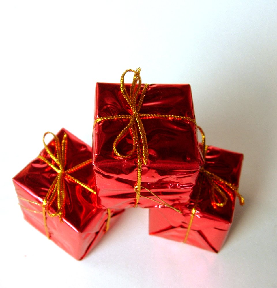 three red boxes with golden strings on them