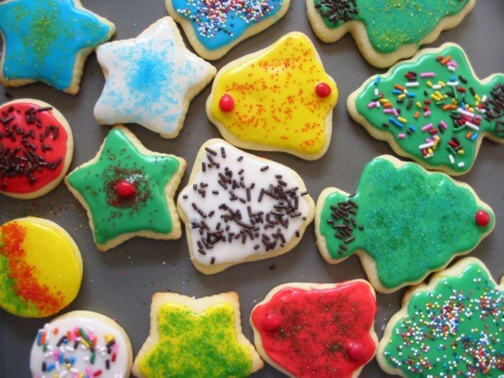 a tray of iced, decorated christmas cookies