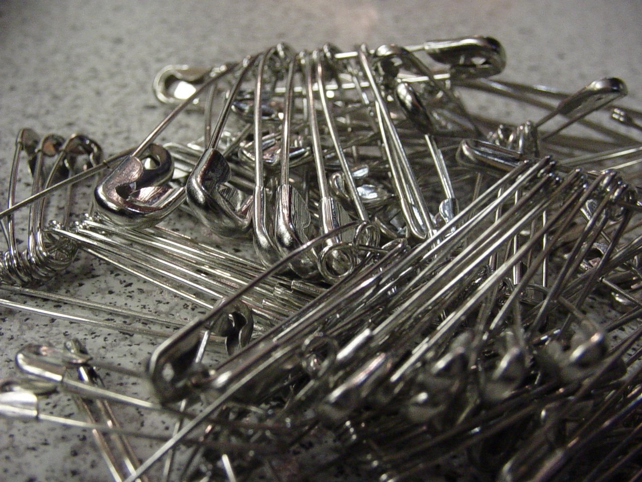 a pile of large and small pins are on the table