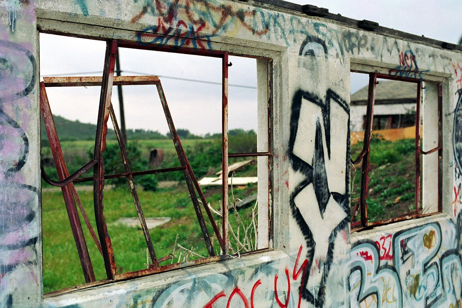 a broken out building that has graffiti on it