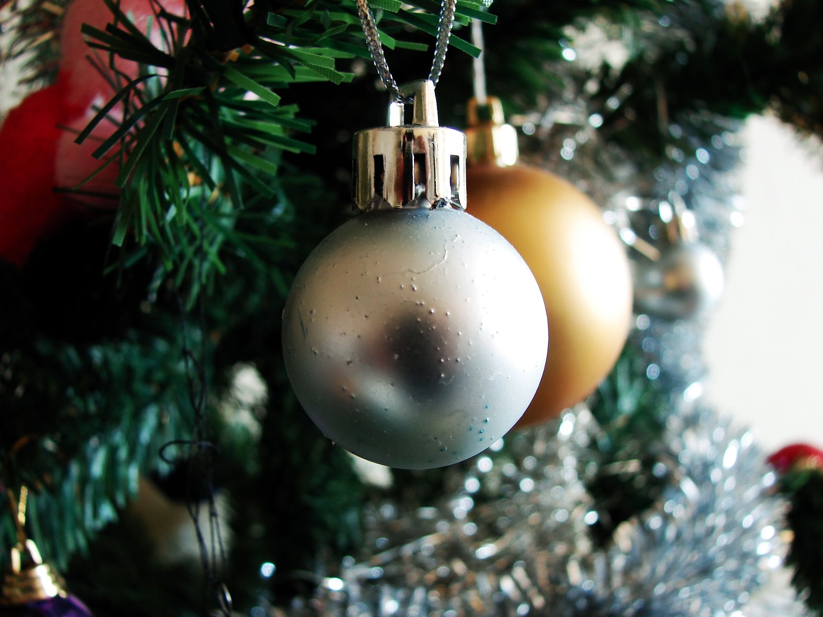 a christmas tree has ornaments and evergreen nches