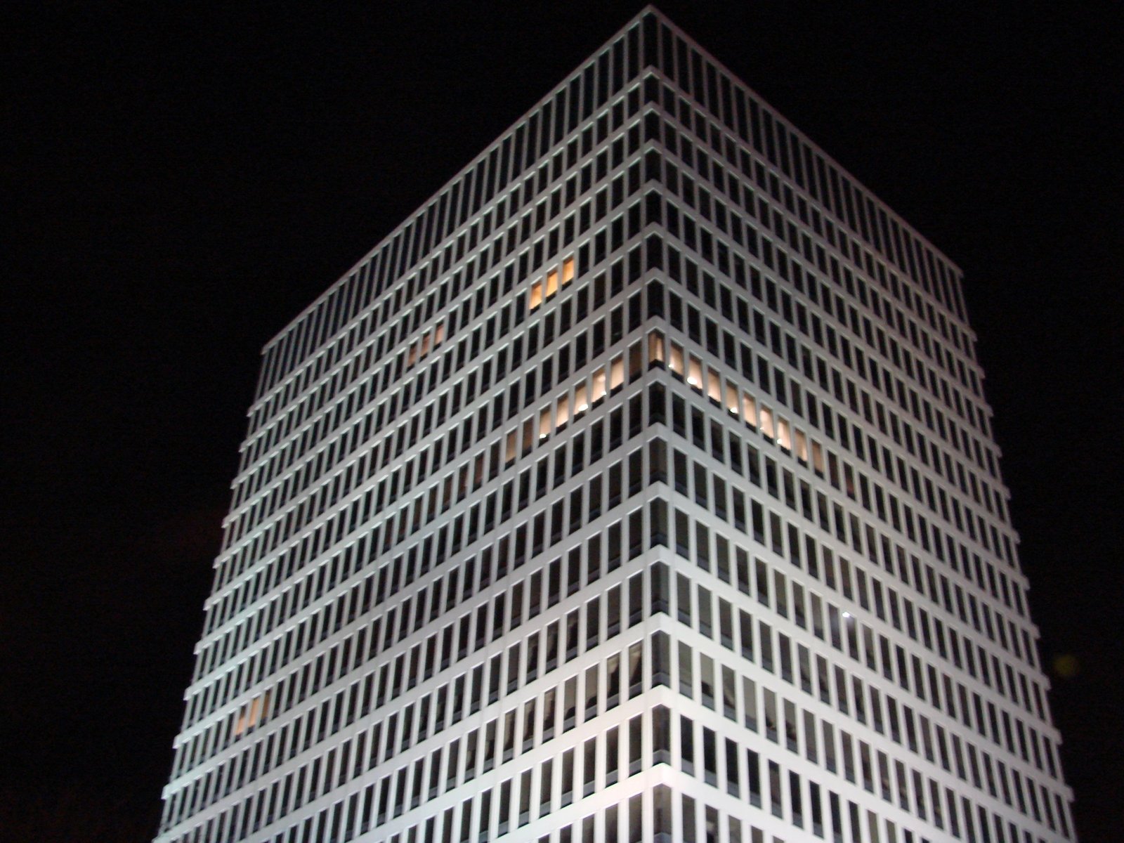 the top of an office building lit up at night