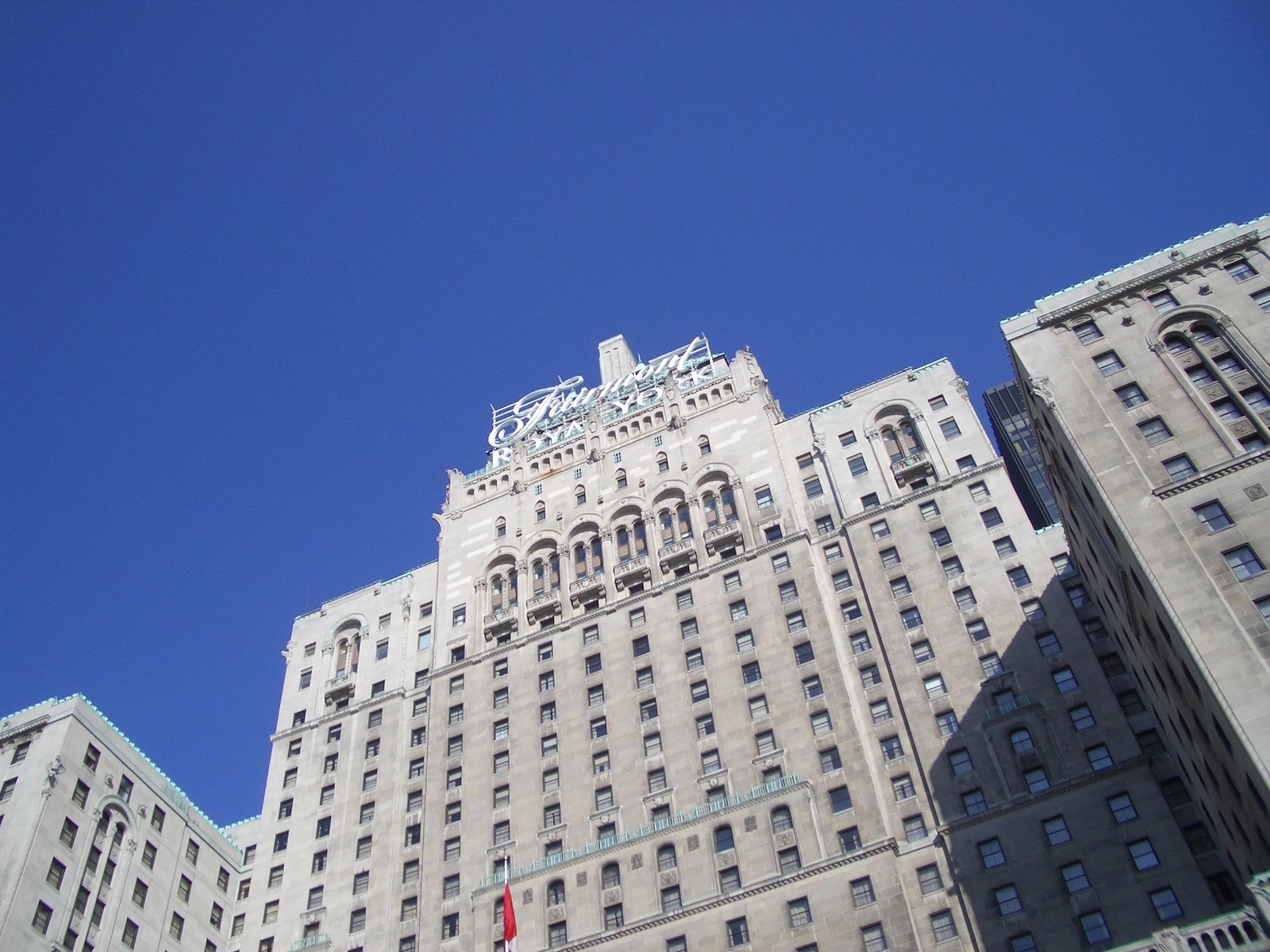 a large white building with many windows and a blue sky