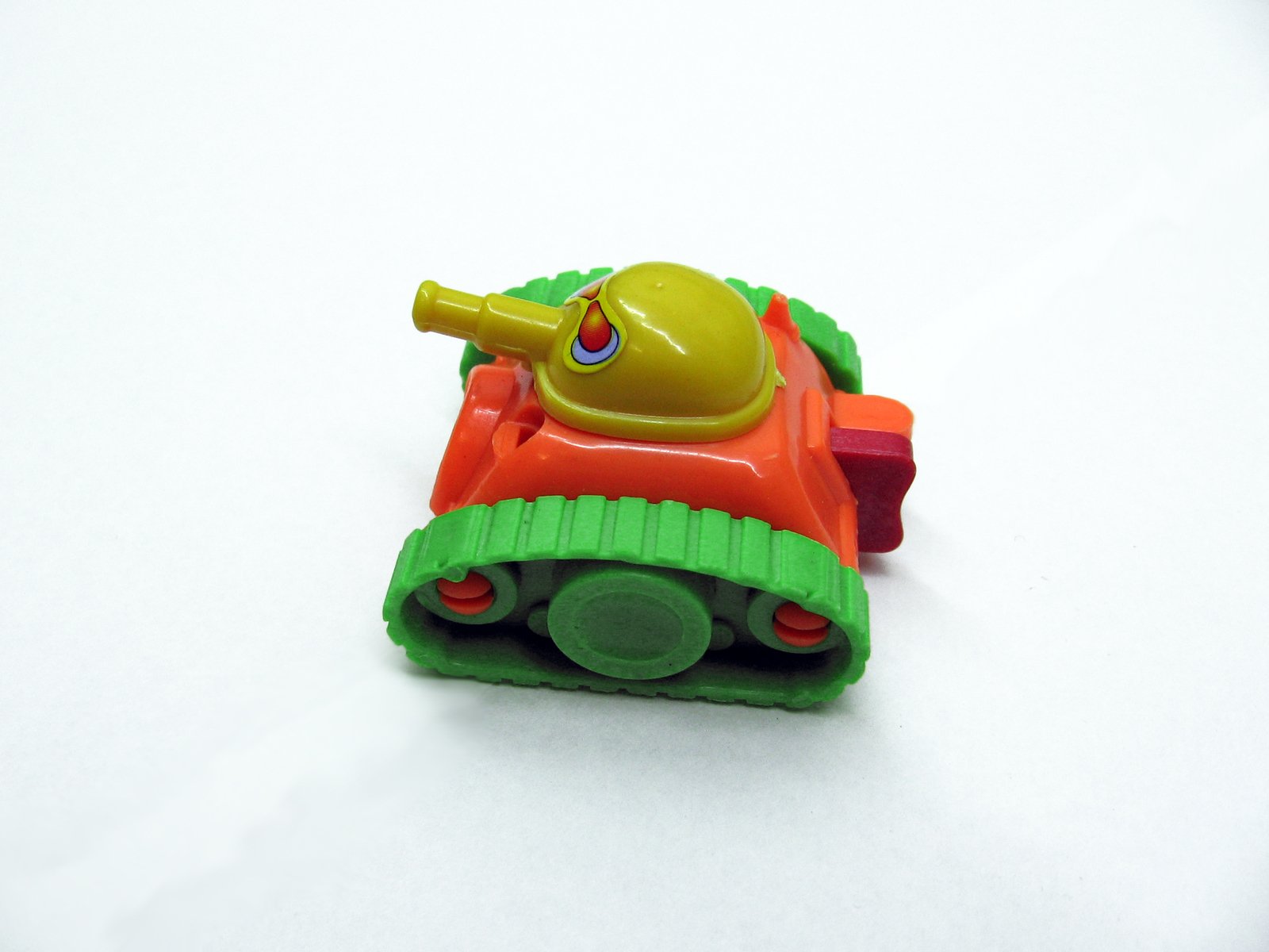 small green and red toy car with orange handle