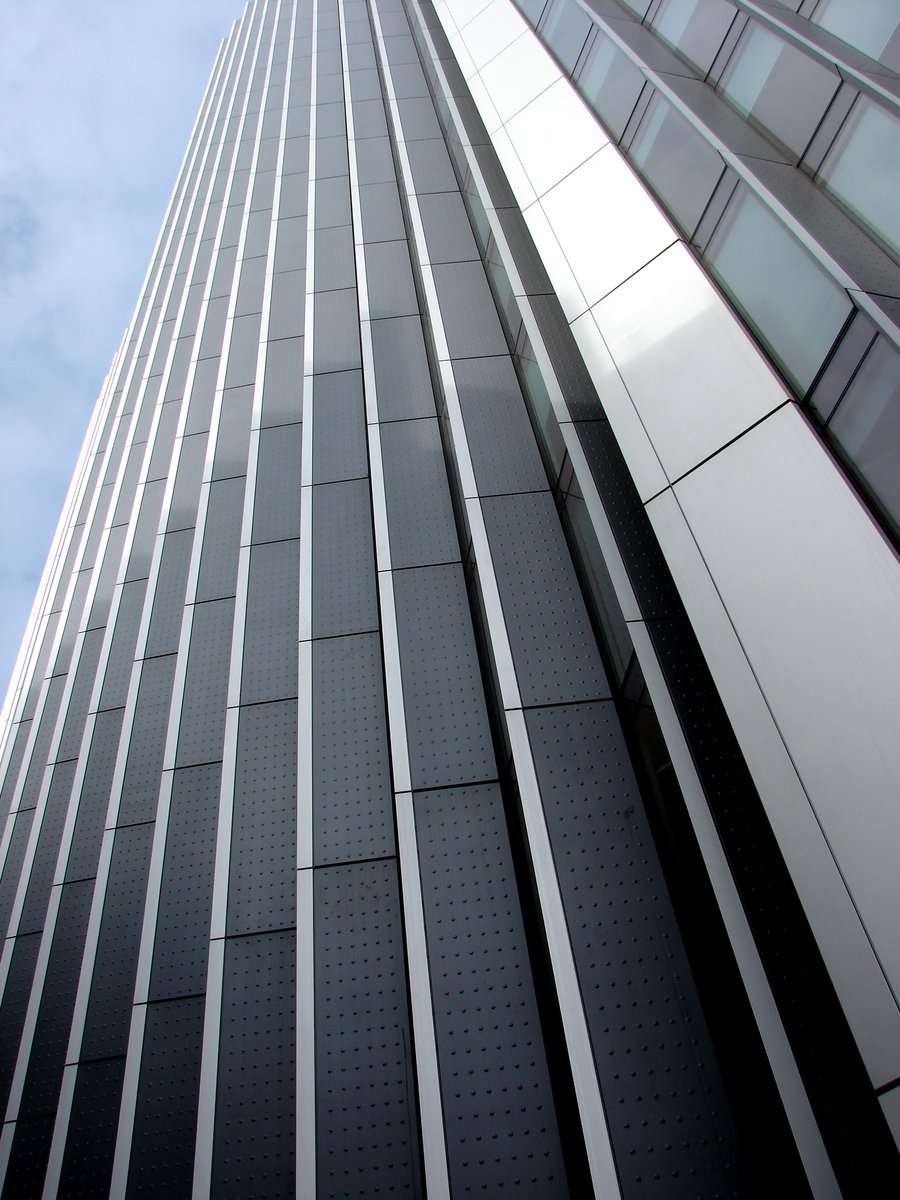 view up at a tall glass - fronted building