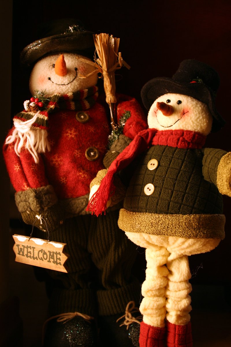 an image of two stuffed snowmen with christmas decorations