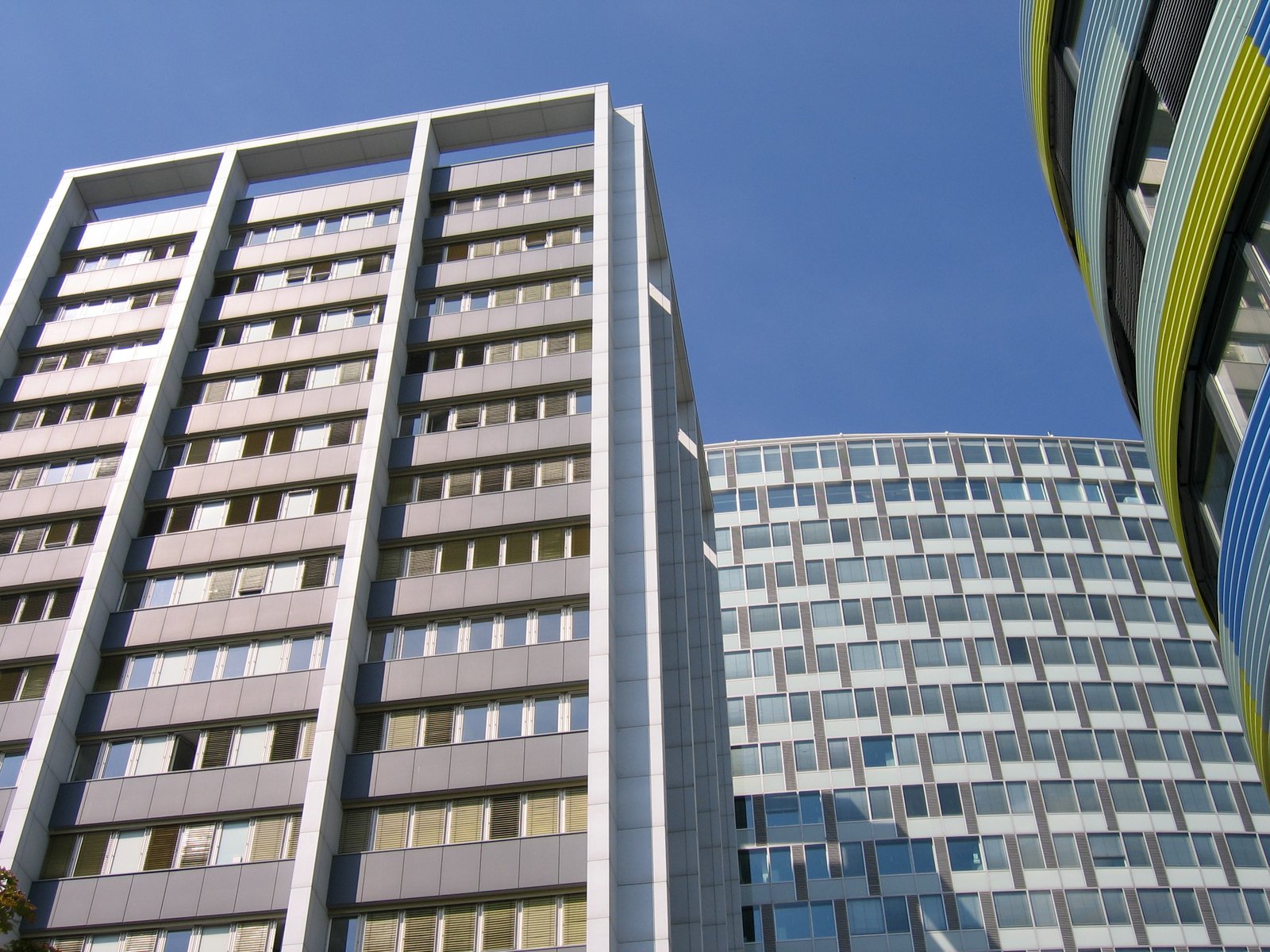 tall building with different windows and blue sky