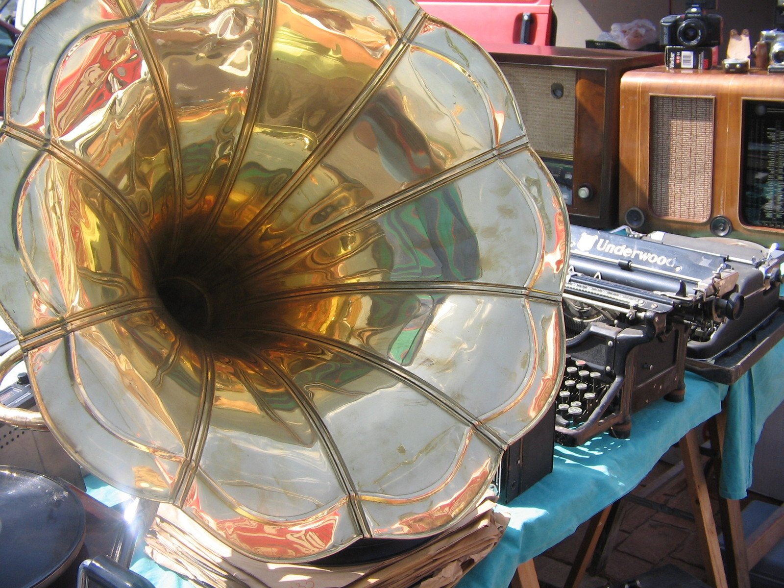 a very big shiny old typewriter with a big horn