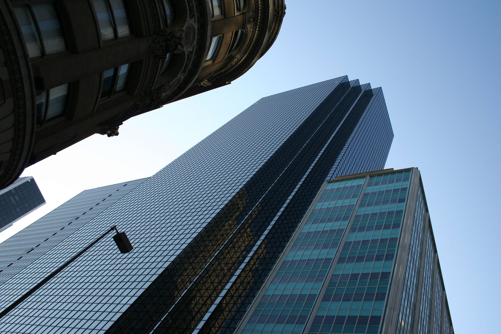 looking up at a large building with three towers