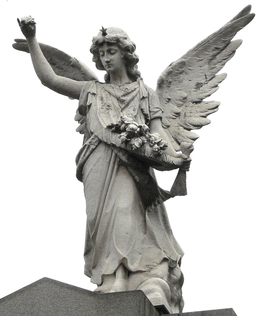 a statue of an angel is sitting on top of a monument