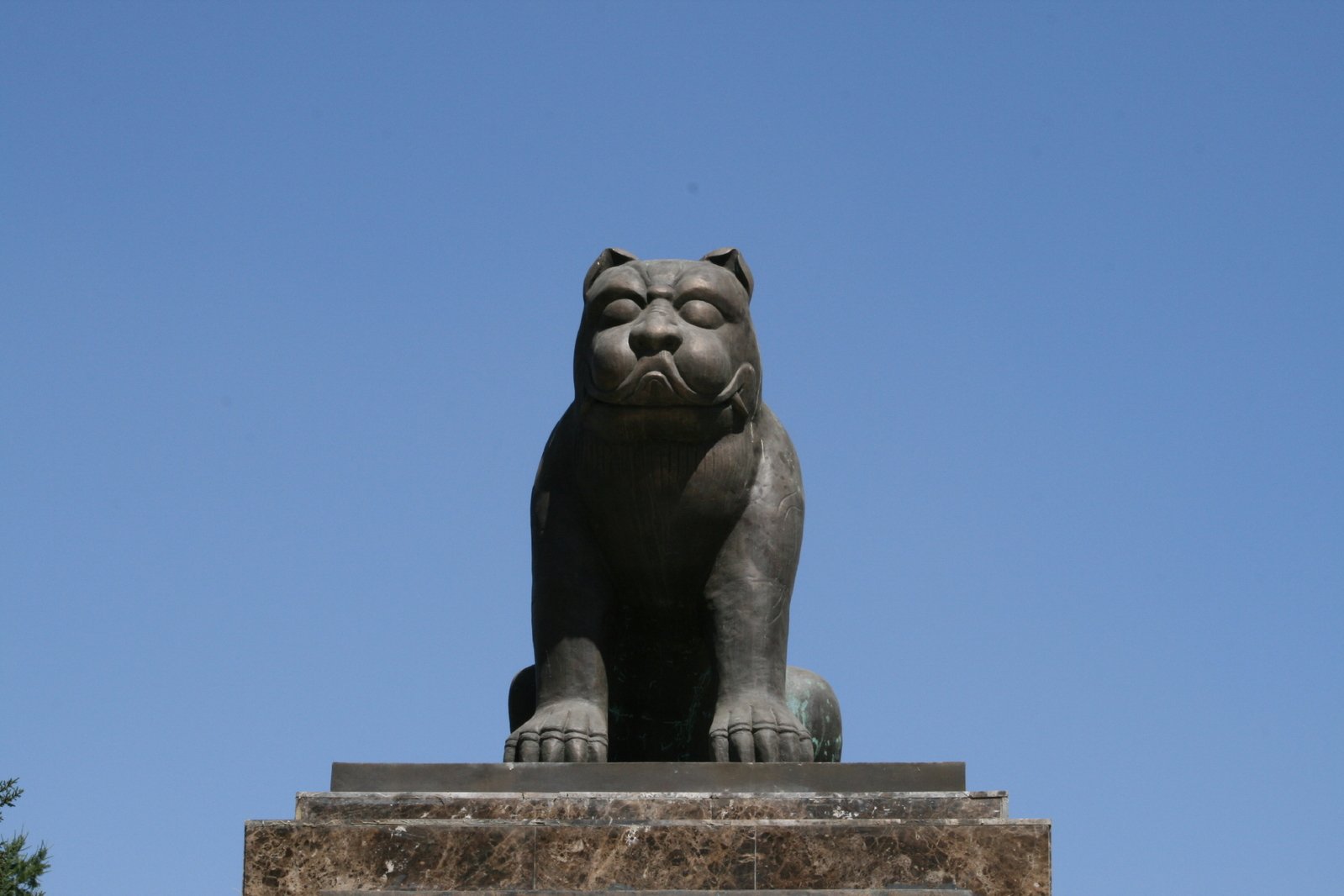 a statue of a lion sitting on a pedestal