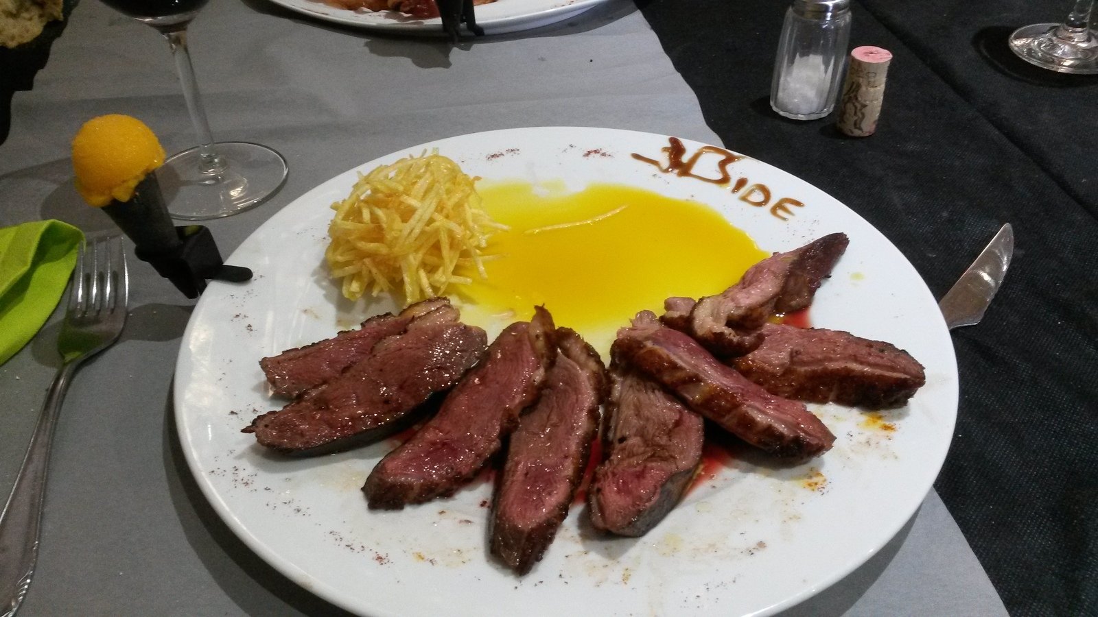 steak, noodles and a fried egg on a table