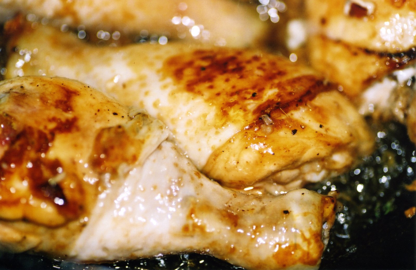 some food is being cooked and cooking in a black pan