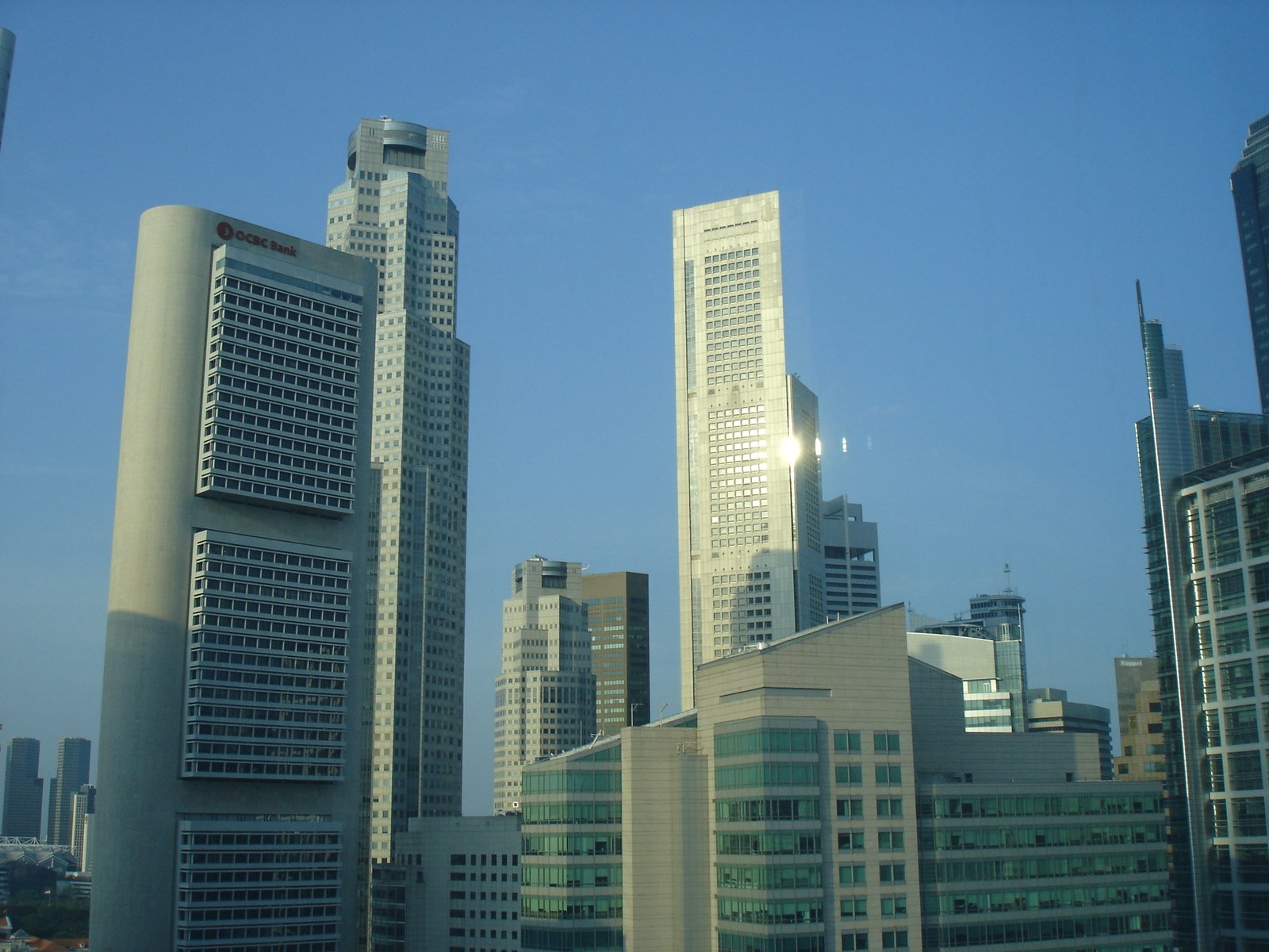 skyscrs in city setting against bright blue sky