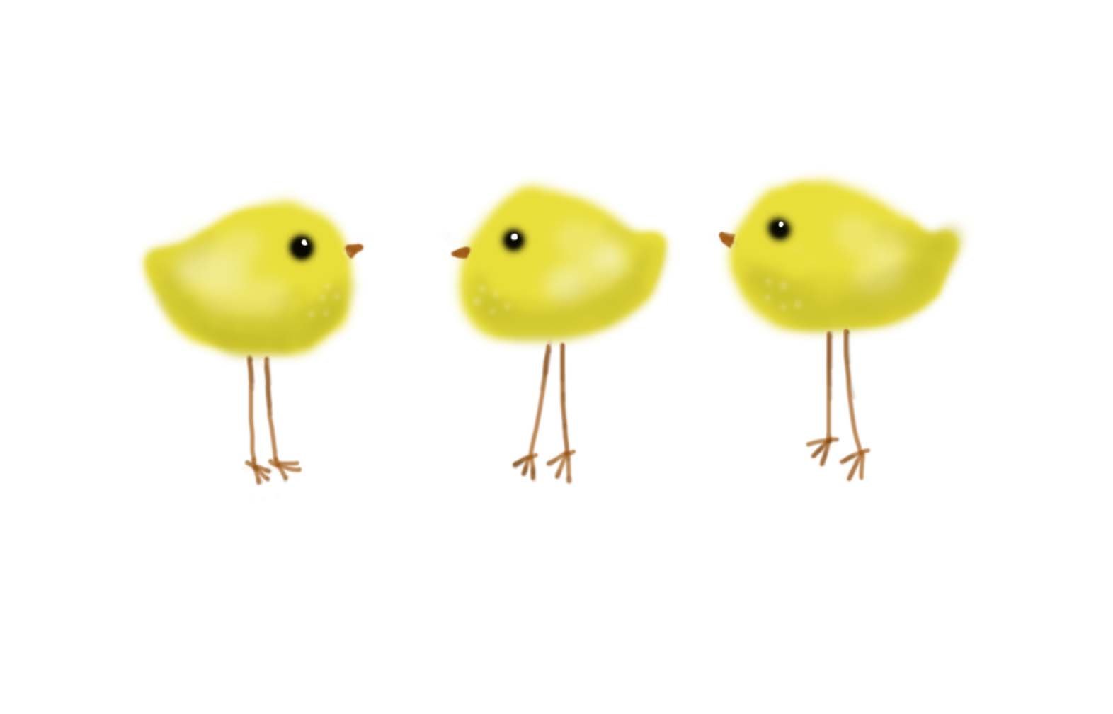 three little yellow birds standing next to each other