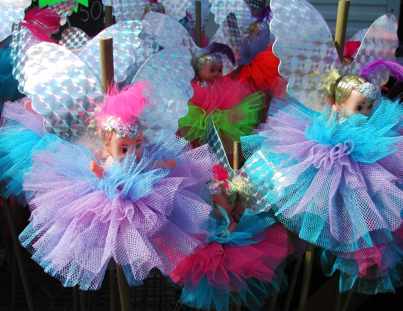 a number of colorful baby doll decorations