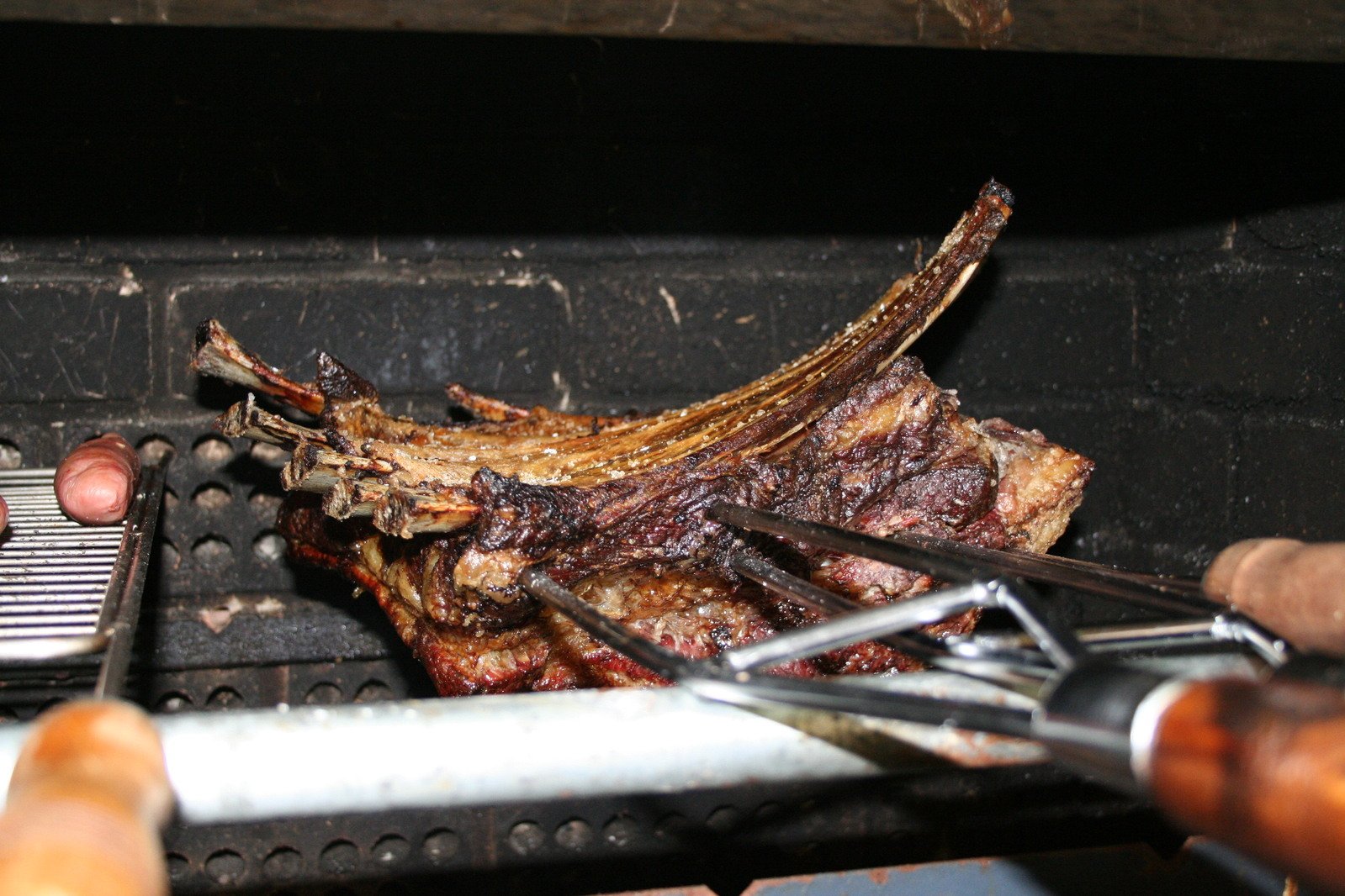 a big piece of meat sitting on top of a grill