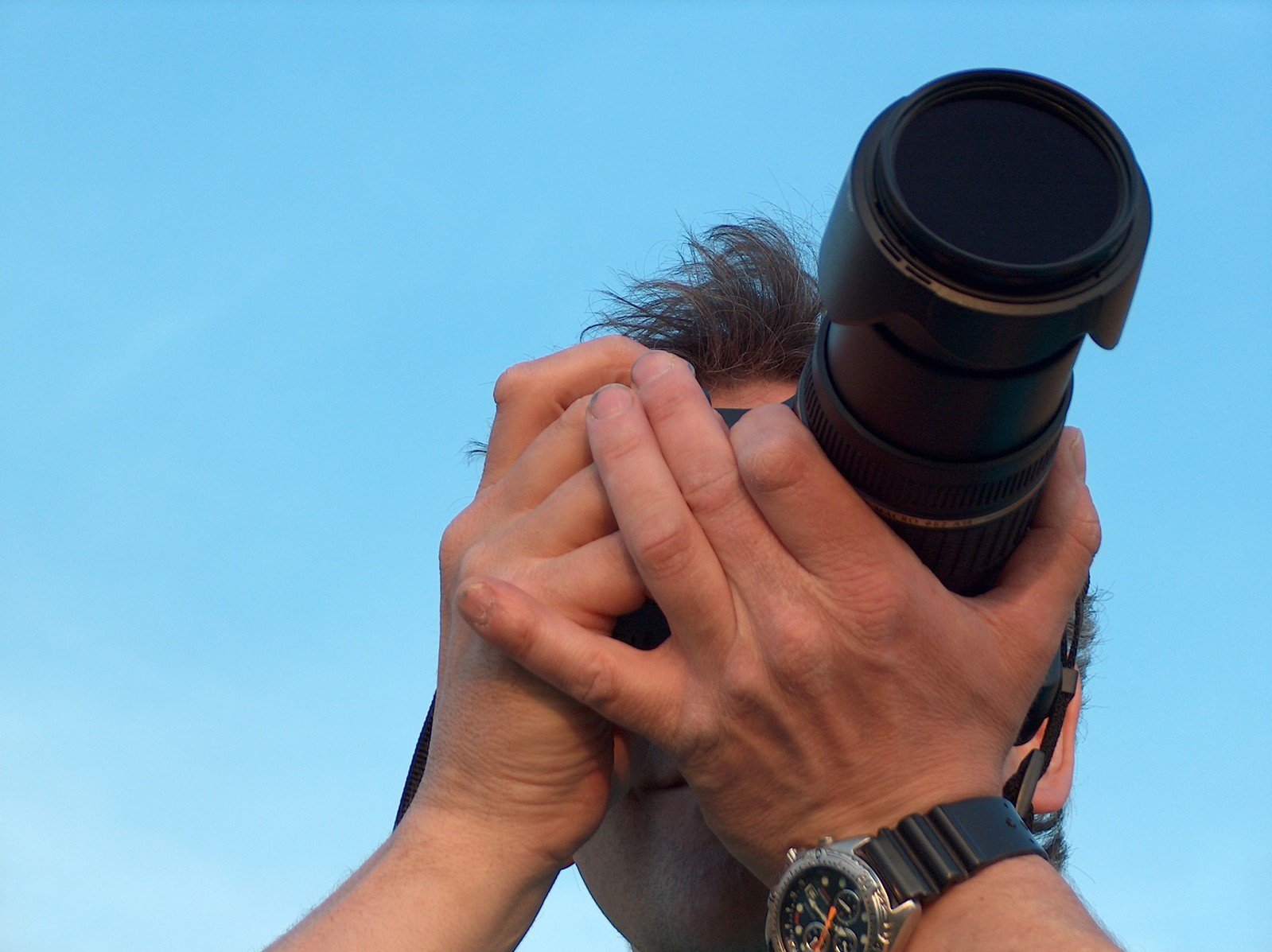 a man is looking through binoculars to the sky