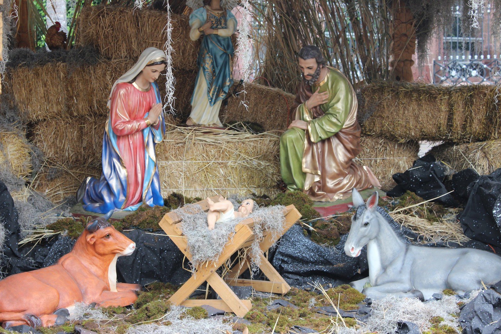 a nativity scene with figurines and a donkey