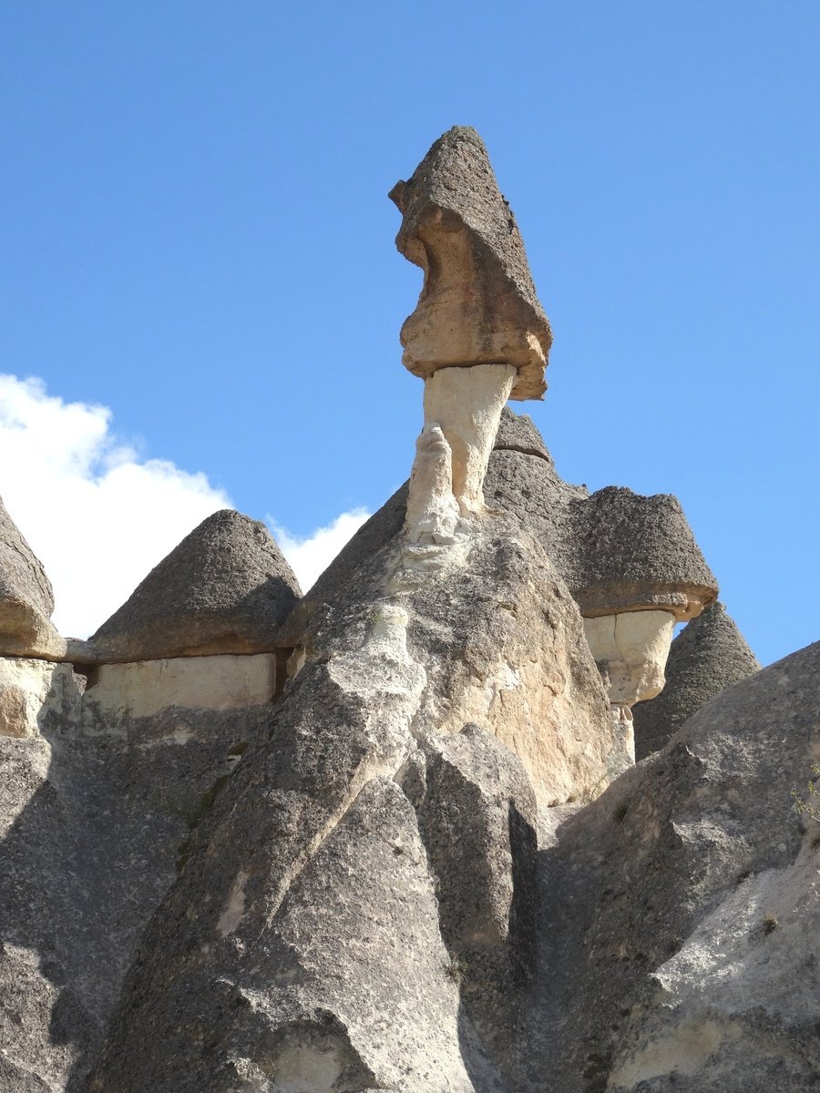 an old rock formation is standing up against a blue sky