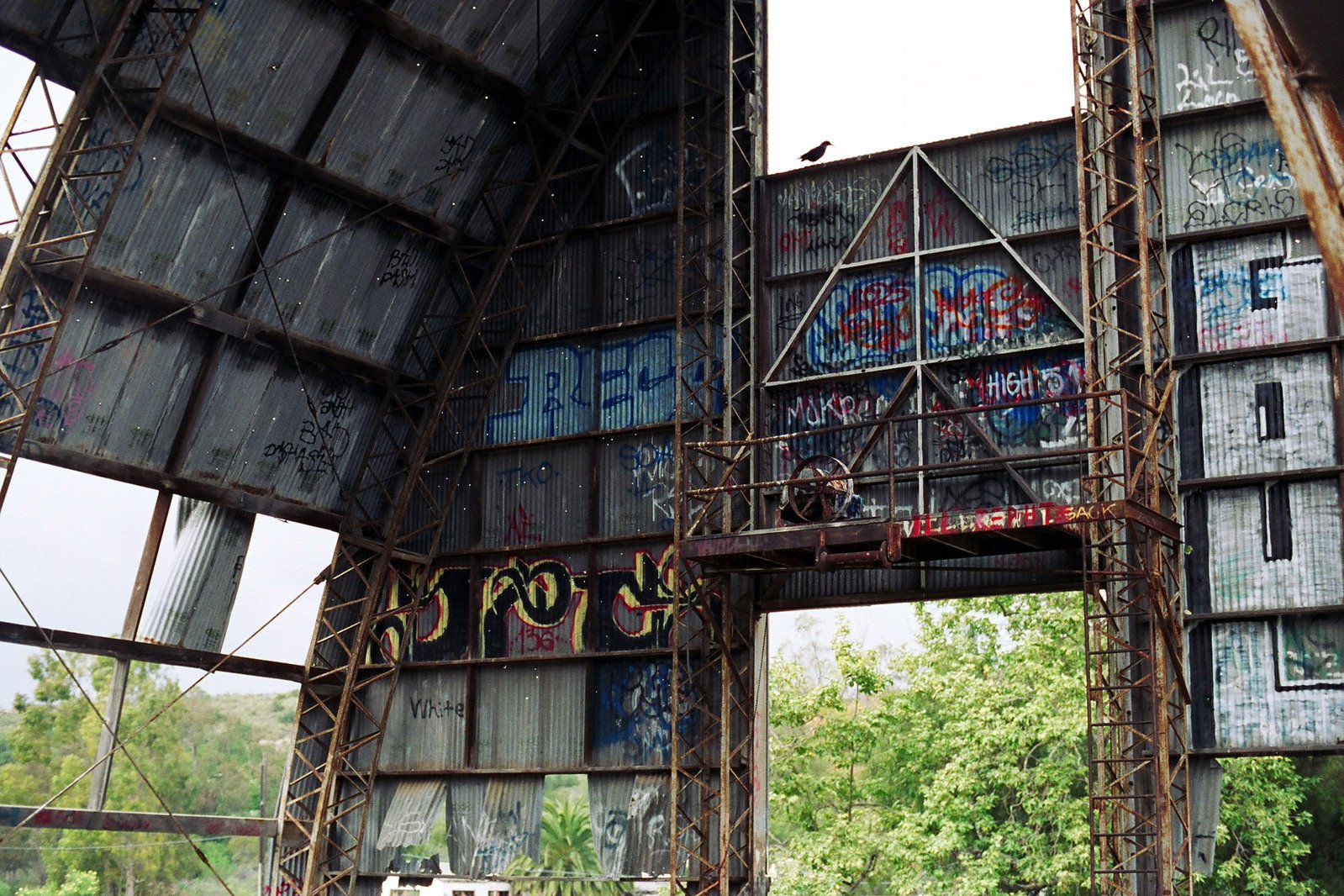 several scaffoldings surrounding an old bridge in a forest