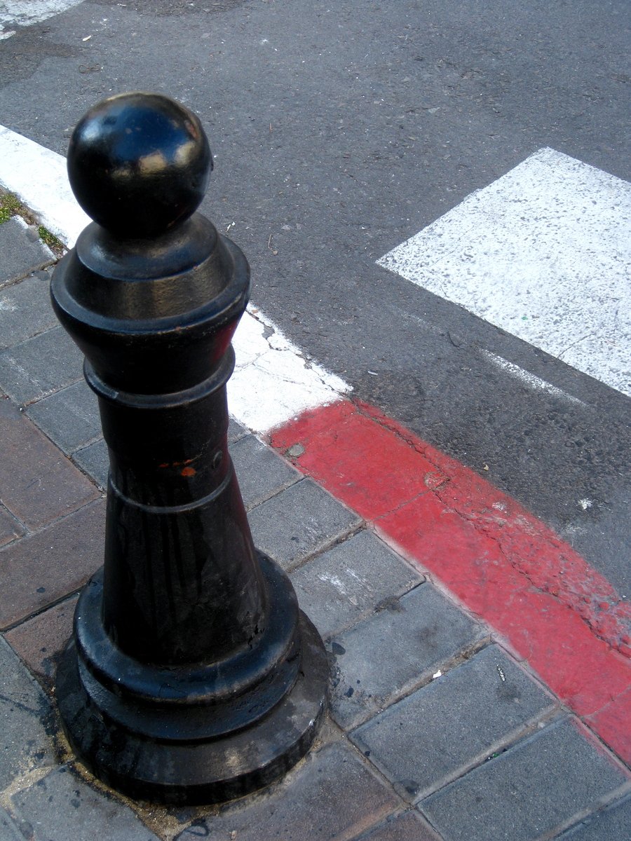 a black fire hydrant standing on the corner