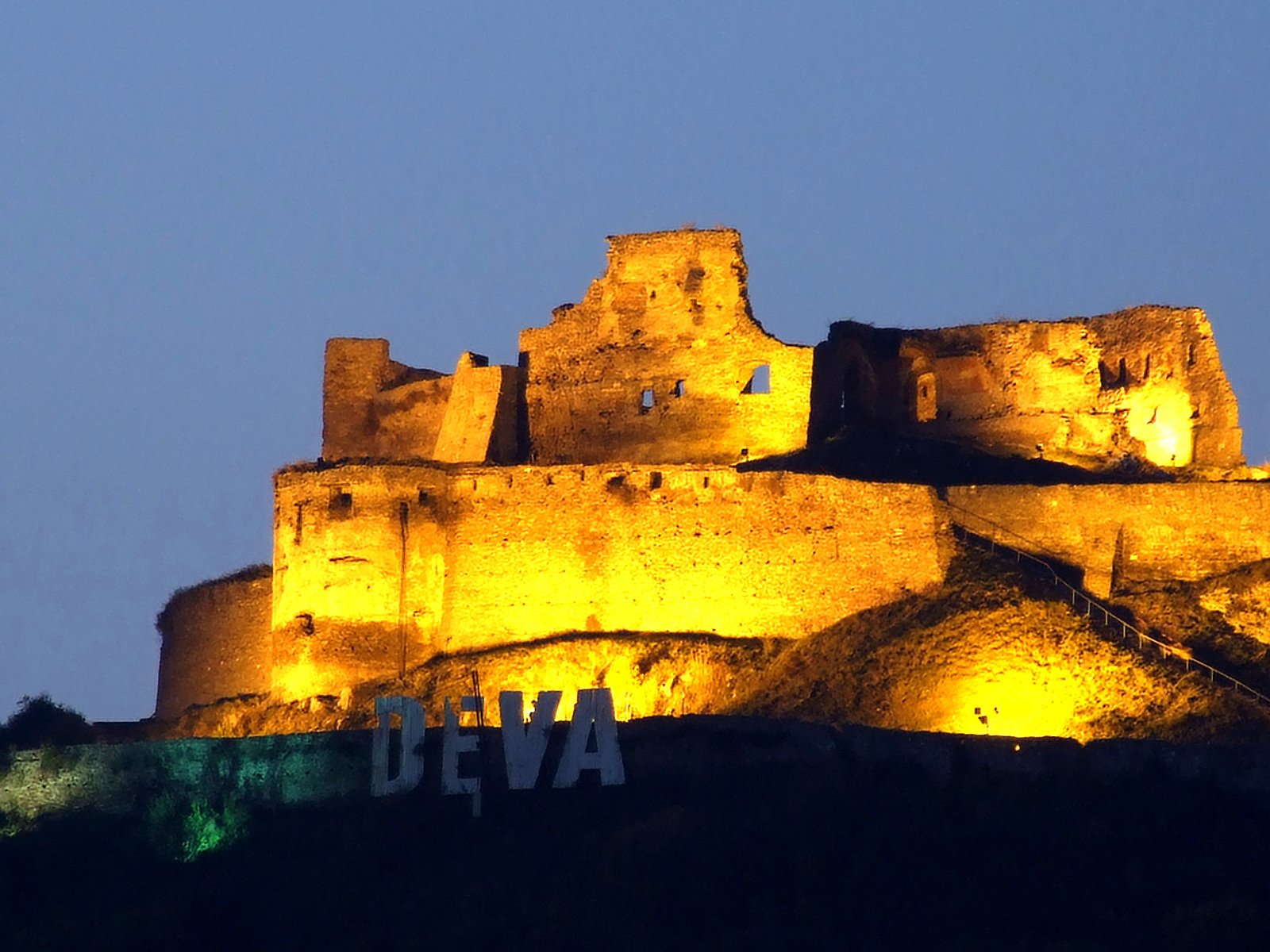 a large castle with some lights on top of it