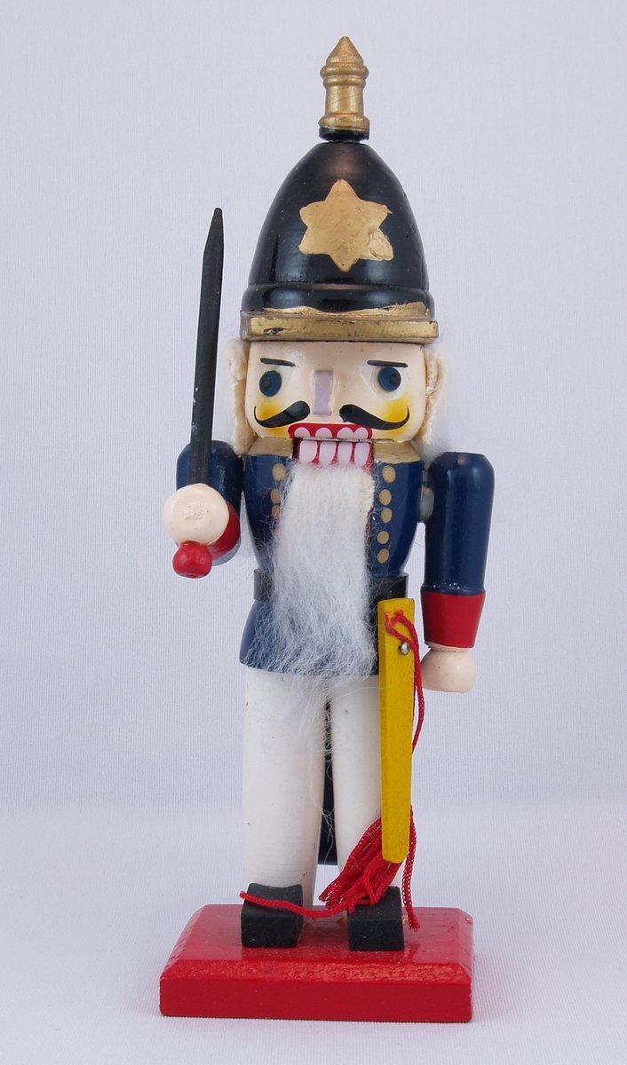 a nutcrier figurine with a sword, and star on its hat