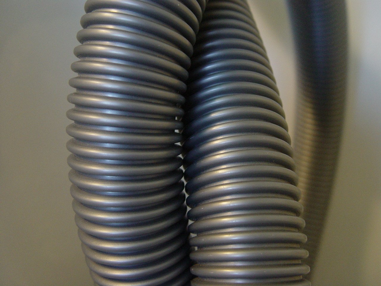 metal tubes of varying sizes on a white surface