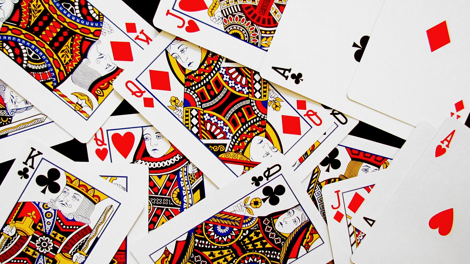 five deckes of playing cards with different colored design