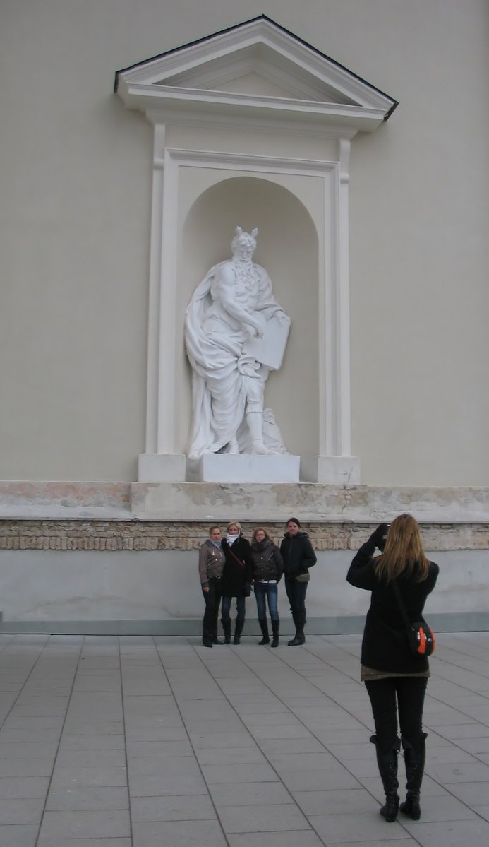 a woman taking a po of a statue