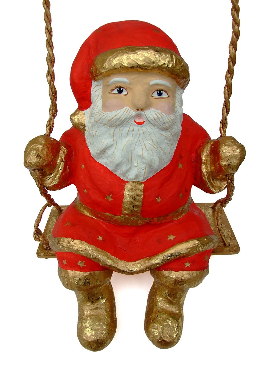 a figurine of santa claus sitting on a swing