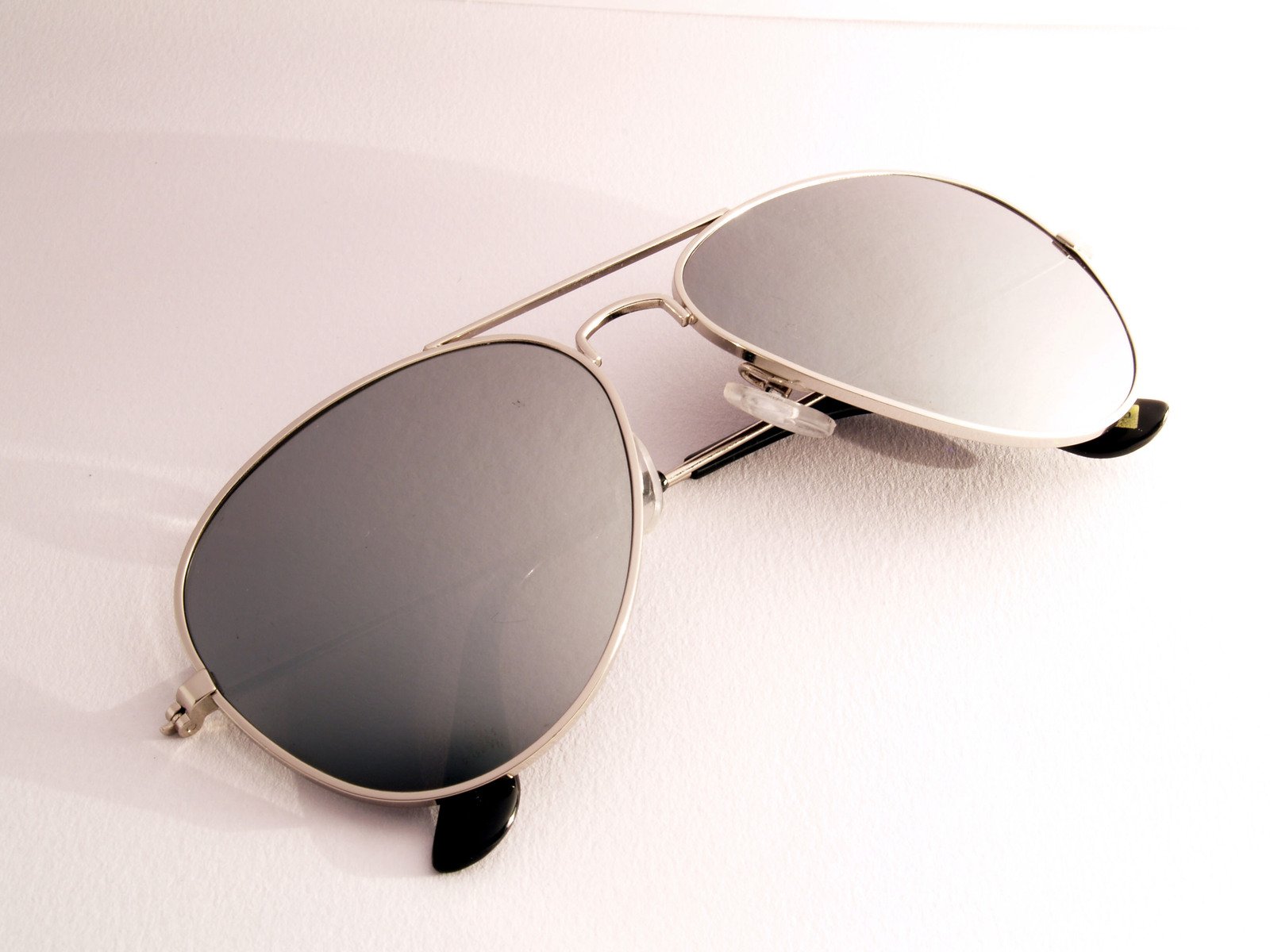 sunglasses with mirrored lenses on top of it