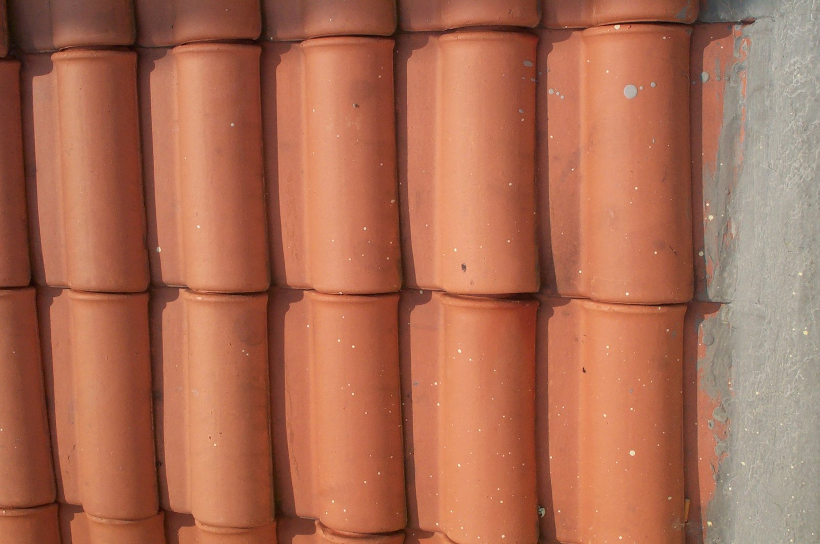 a line of bricks sitting in a row against a wall