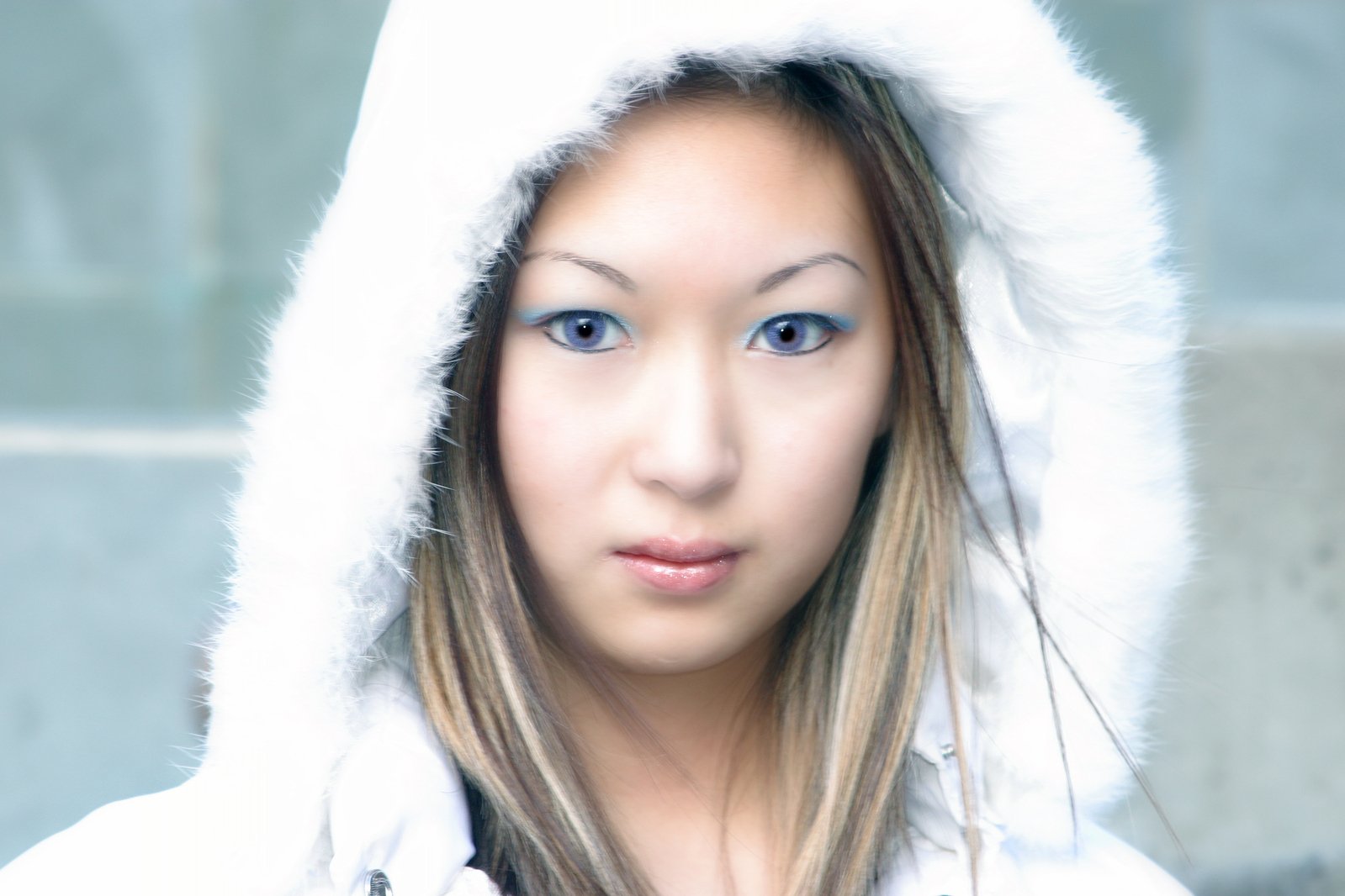 the young woman is wearing a white fur hoodie