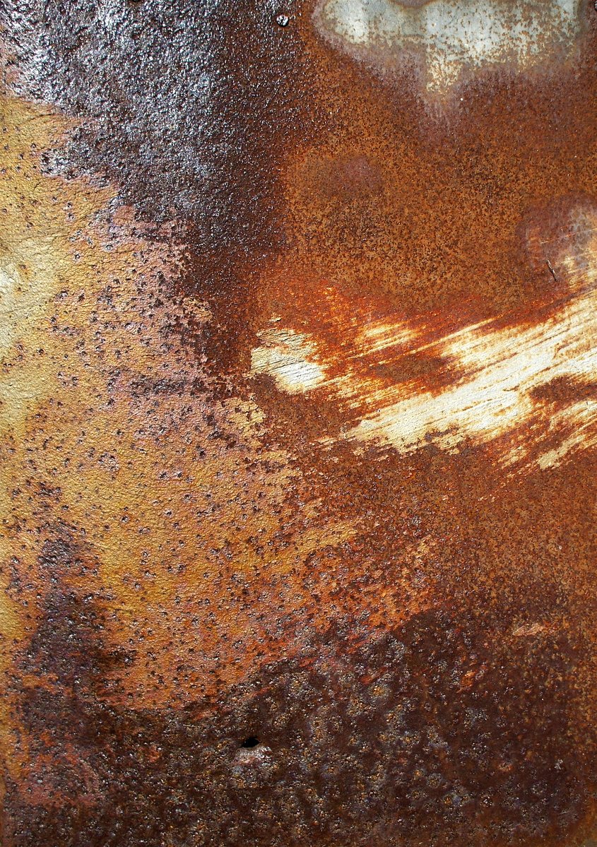 the top half of a plate, with rusted gold paint on it