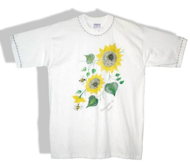 a white shirt with yellow sunflowers and green leaves