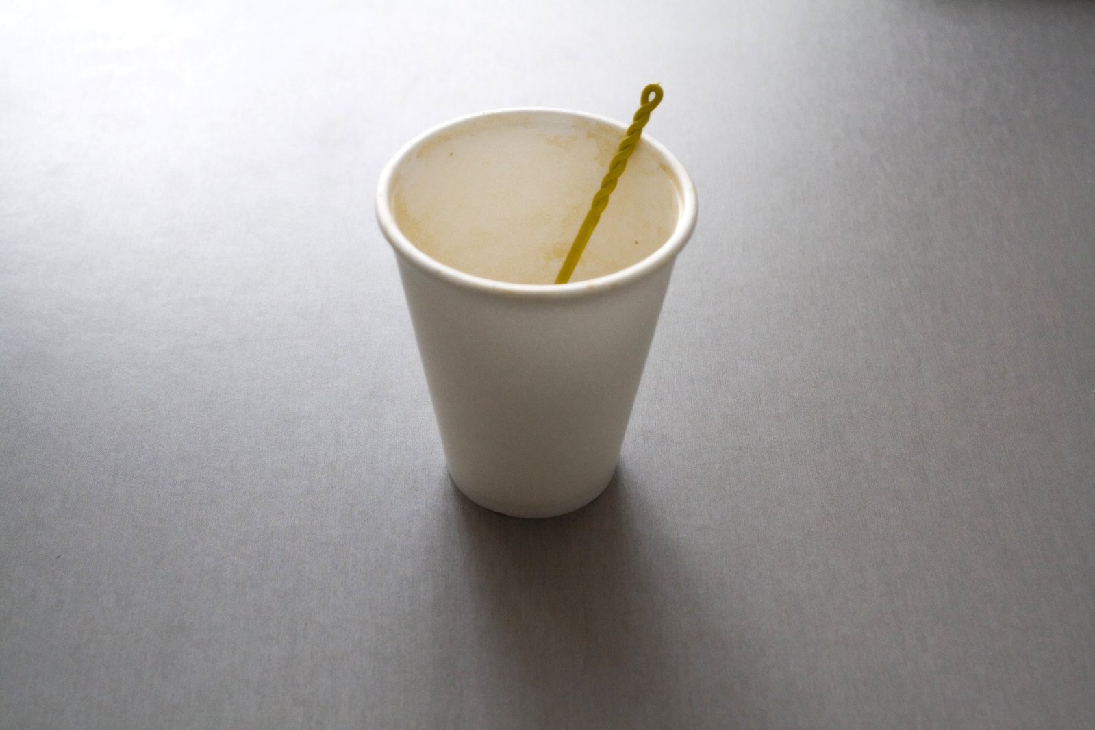 a cup with a straw in it sits on the table