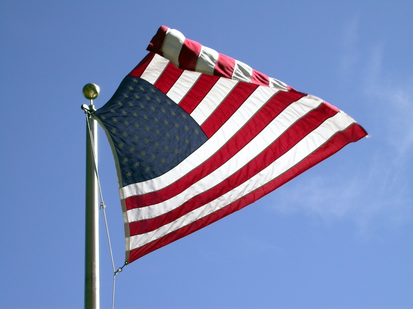 a large red white and blue american flag flying