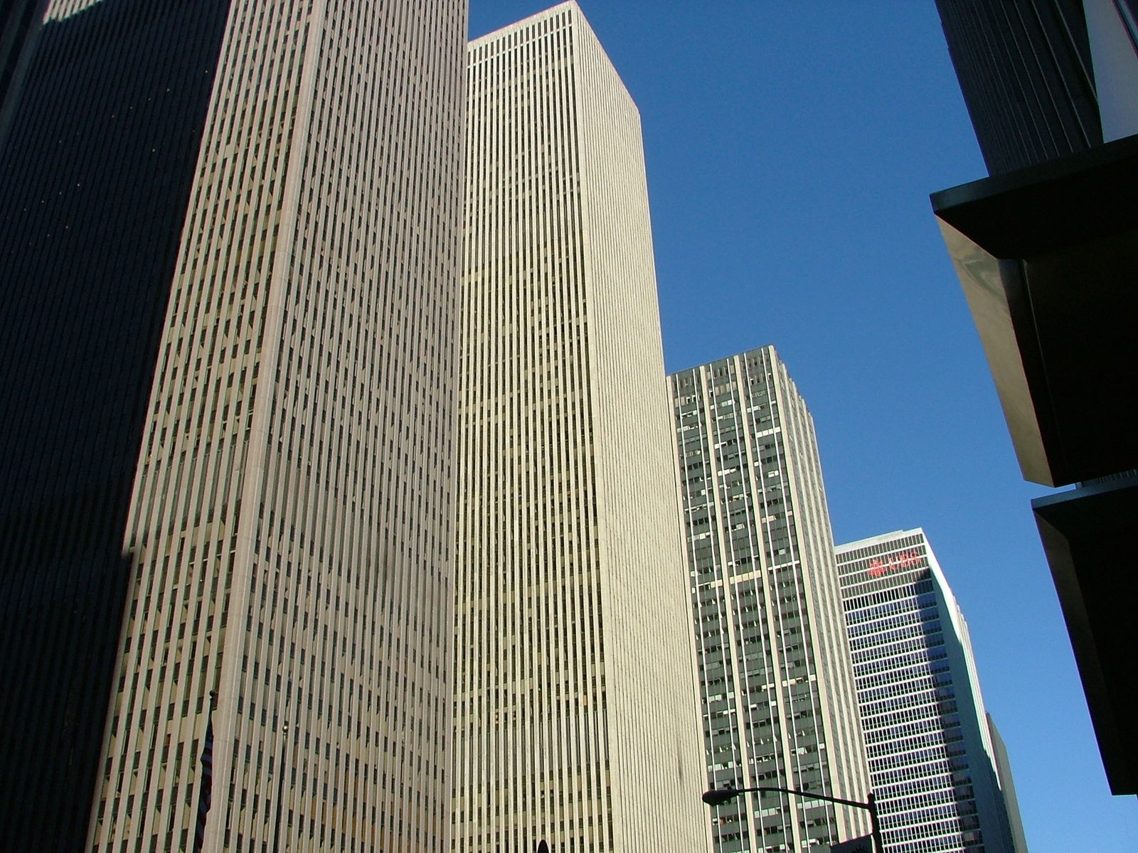 two very tall buildings next to each other in a big city