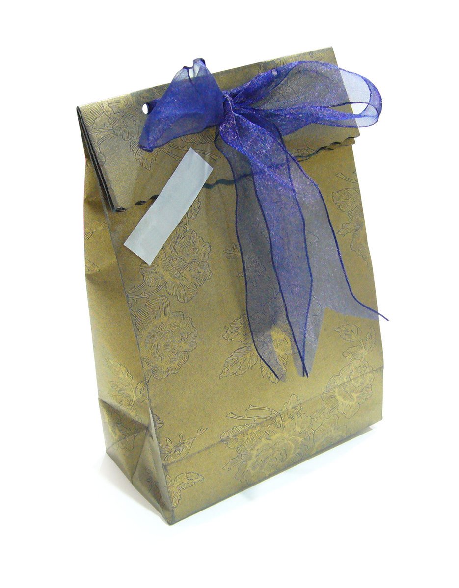 a brown bag with purple ribbon tied to it