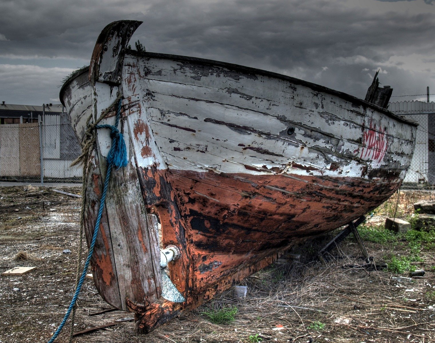 old rusty boat left on land in abandoned city