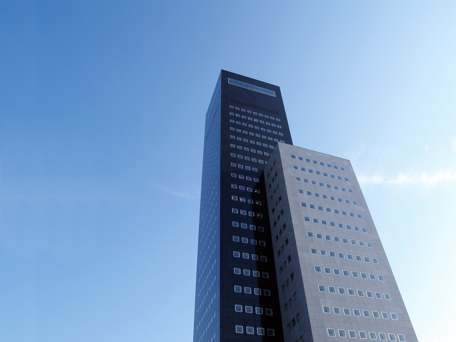a tall building in front of a blue sky
