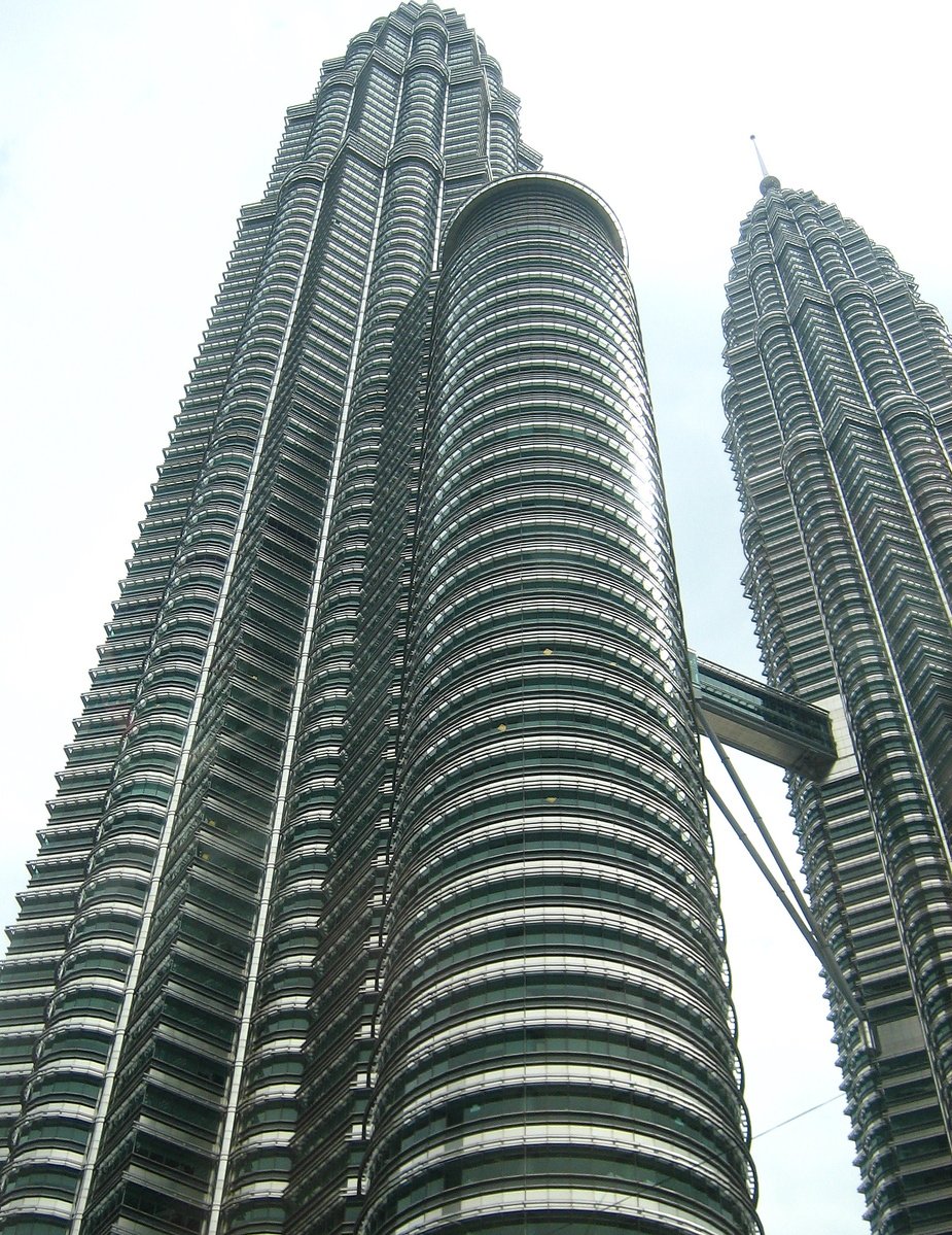 two very tall buildings with metal lines on them